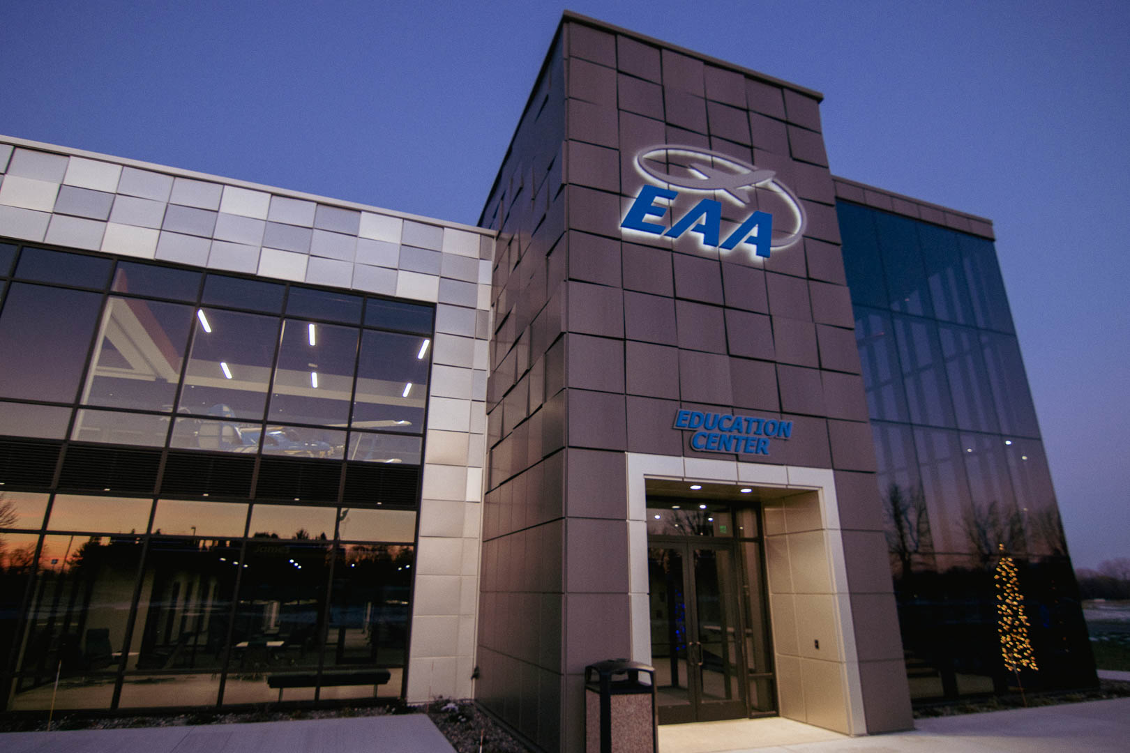 The front entrance of the Experimental Aircraft Association's (EAA) new education facility at dusk.